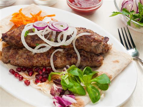 Premium Photo Kebab On Pita Bread With Onions And Pomegranate Seeds