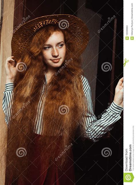 Lovely Young Red Haired Model With Freckles In Straw Hat Posing Stock