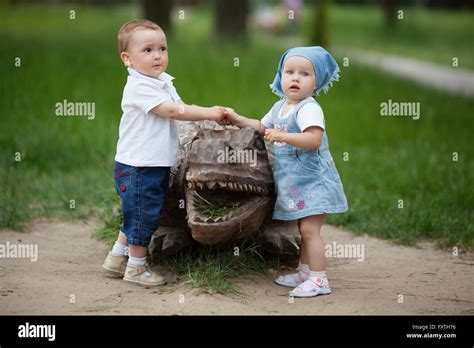 Boy And Girl With Wooden Crocodile Stock Photo Alamy