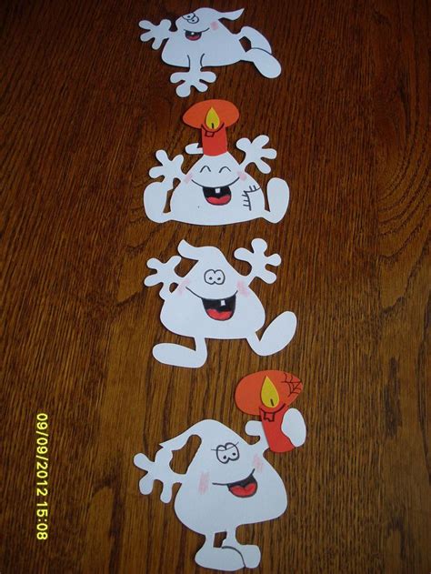 Three Stickers Depicting Ghost Characters On A Wooden Table With A