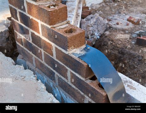 Damp Proof Membrane Being Built Into A Brick Wall House Extension Stock