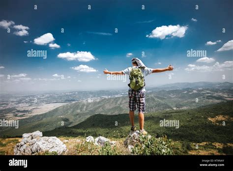 Male climb at the top of mountain, celebrating success Stock Photo - Alamy