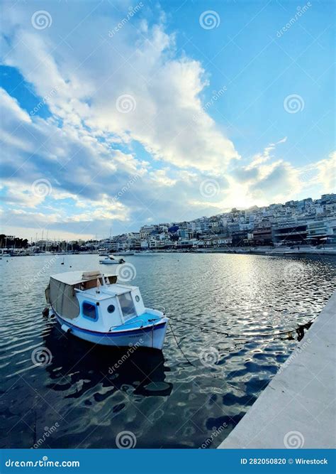 Picturesque Scene Of A Solitary Sailboat Peacefully Bobbing In The