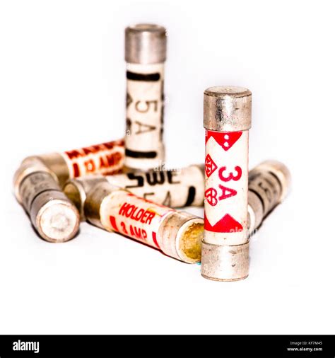 A Small Collection Of Three And Five Amp Fuses Shot Against A White