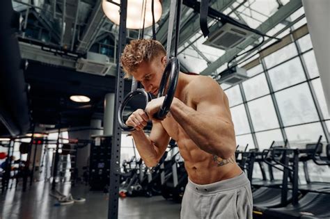 Premium Photo Strong Man Doing Exercise On To Gymnastic Rings At Gym