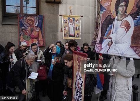 Orthodox Christian believers hold religious icons and pray during the ...
