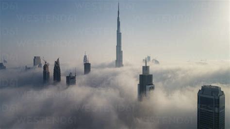 Aerial View Of Skyscrapers And Burj Khalifa Tower In The Clouds Of