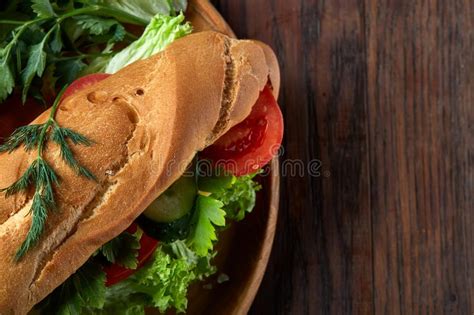 Fresh Sandwich With Lettuce Tomatoes And Cheese Served On Wooden Plate