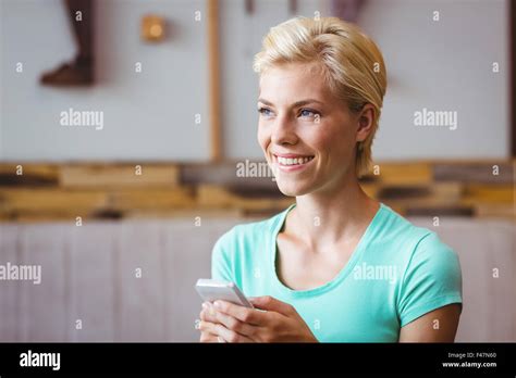 Pretty Blonde Woman Using Her Smartphone Stock Photo Alamy