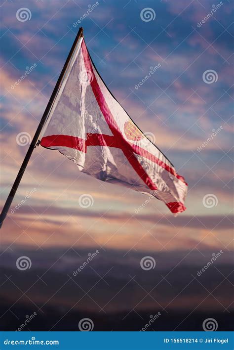 Bailiwick of Jersey Flag, Jersey Flag Waving on Sky at Dusk Stock Photo ...