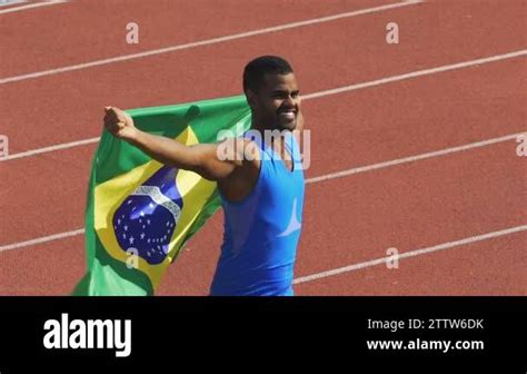 Flag Of Brazil Waving In Wind Athlete Showing His Strength Winning