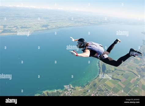 A Woman Making A Fun Skydive Above Lake Neuchatel In Switzerland Stock