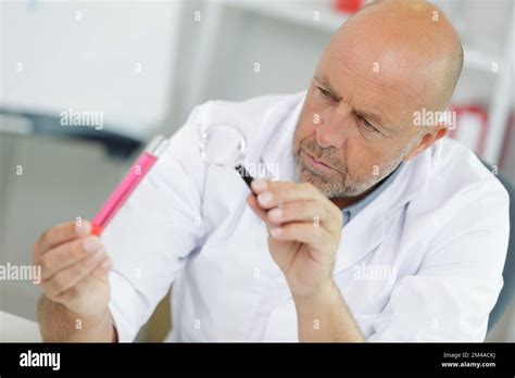 Mature Scientist With Magnifying Glass Outdoors Stock Photo Alamy