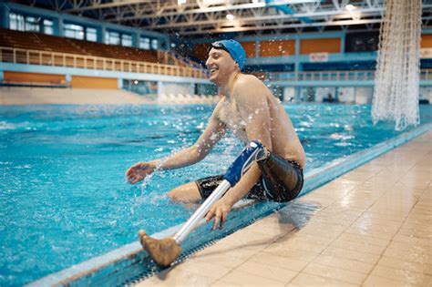 Athlete With A Prosthetic Leg Having Fun While Splashing Water By The