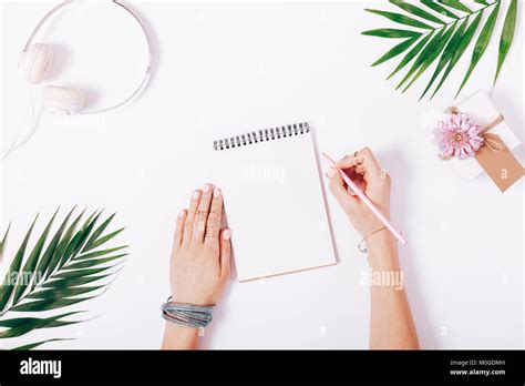 Female Hands Write In A Notebook At The Desk Top View Stock Photo Alamy