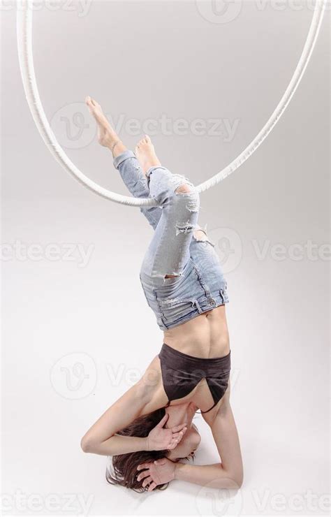 A female Aerial hoop gymnast performing exercises on an Aerial hoop ...