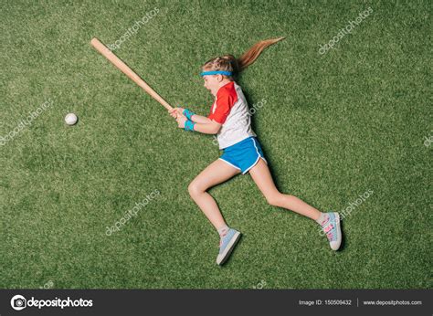 Download Top View Of Little Girl Pretending Playing Baseball On Grass