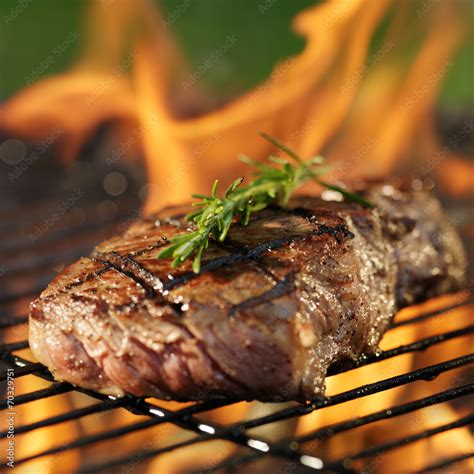 Steak Cooking Over Flaming Grill Stock Photo Adobe Stock