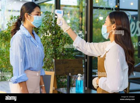 Asian Woman Cafe Employee Take Temperature Asian Woman With Face Mask