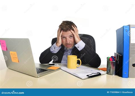 Exhausted Businessman Suffering Stress At Office Computer Desk