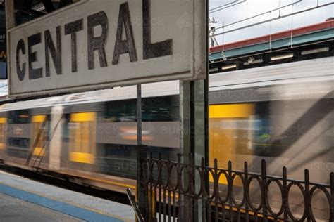 Image of Central railway station sign with train passing the platform ...