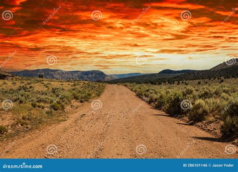 A Rural Dirt Road Leading Off To Distant Mountains Stock Photo Image