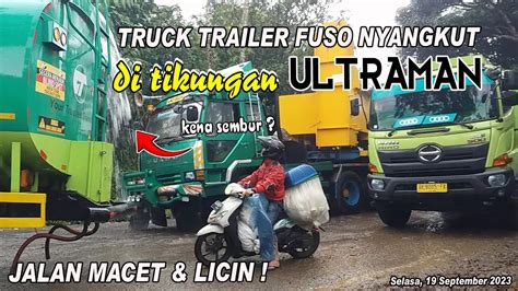 TRUCK TRAILER BERMUATAN SUPER PANJANG TERPURUK MENGAKIBATKAN MACET