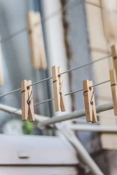 Wooden Clothespins On A Clothesline Blur Light Photo The Concept Of