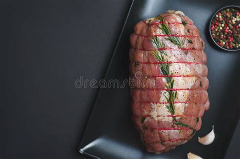 Raw Uncooked Pork Rolled Meat With Herbs And Seasoning Stock Image