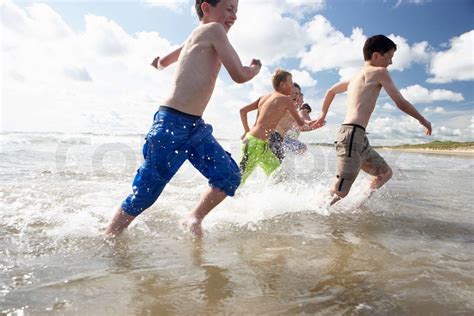 Teenagers Playing On Beach Stock Image Colourbox