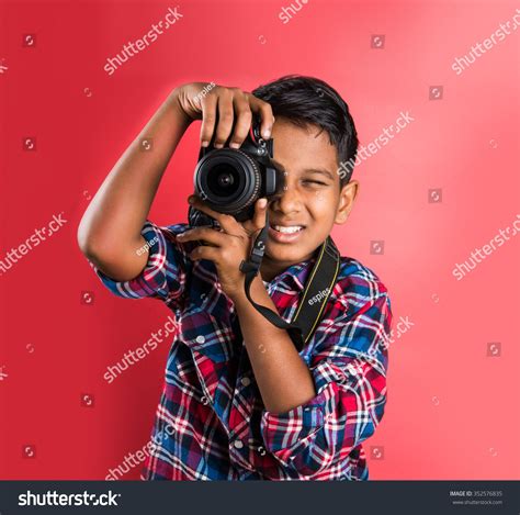 10 Year Old Indian Boy Holding Digital Camera Or Dslr Camera Posing Like A Professional