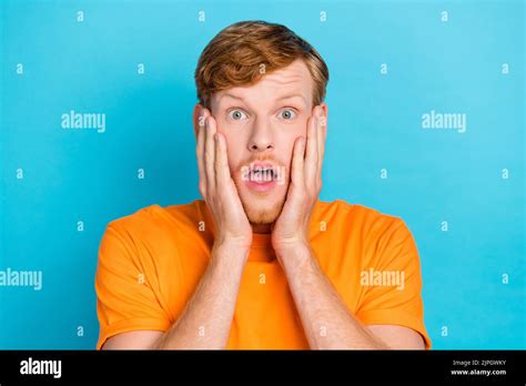 Photo Of Impressed Red Hair Guy Hands Face Wear Orange T Shirt Isolated