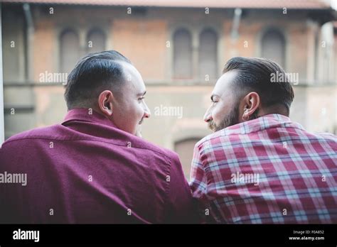 Gay Couple Looking Out Of Window Stock Photo Alamy