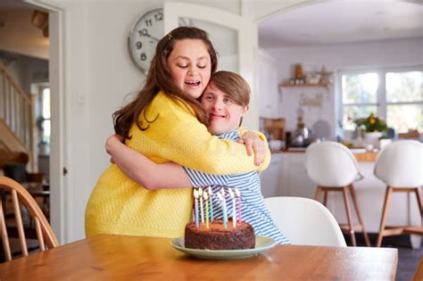 Young Downs Syndrome Couple Decorating Homemade Cupcakes With