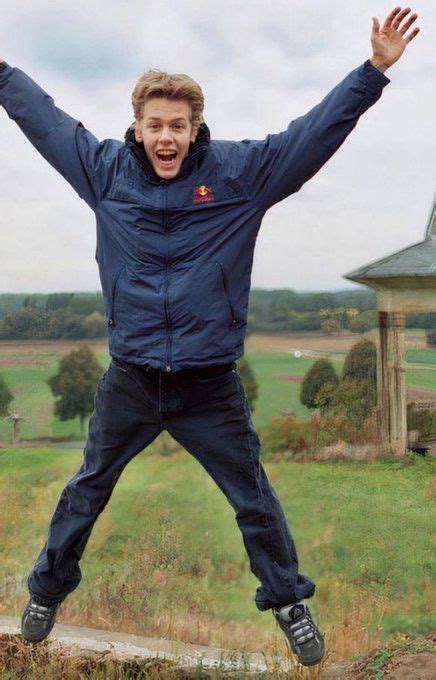 A Man Is Jumping In The Air With His Arms Wide Open And One Hand Up