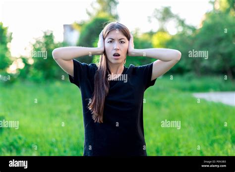 The Brunette Girl With Long Hair Summer In Nature Hands Closed Her Ears Loudly Screaming Loud