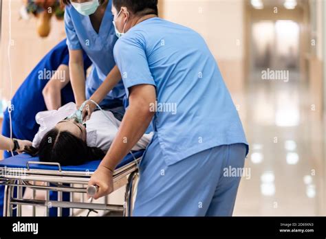 Close Up Medical Team Do Cpr To Seriously Injured Patient With Oxygen Mask While Push Gurney