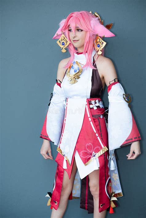 Female Cosplayer in a Pink Anime Costume Wearing Pink Hair Stock Photo ...