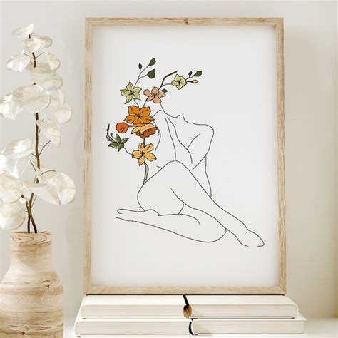 A Drawing Of A Naked Woman With Flowers In Her Hair Sits On A Shelf