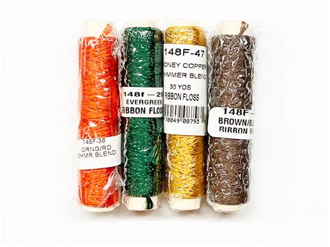 Four Different Colored Sprinkles In Plastic Bags On A White Surface