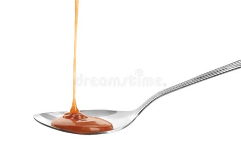 Tasty Caramel Sauce Pouring Into Spoon Isolated Stock Image Image Of