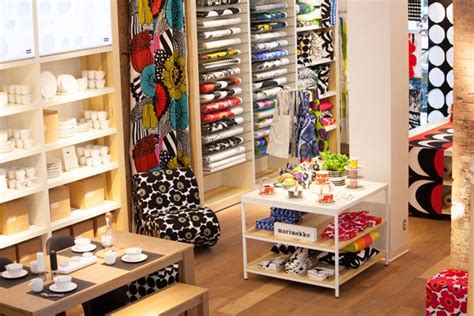 The Inside Of A Clothing Store With Lots Of Items On Shelves And Tables