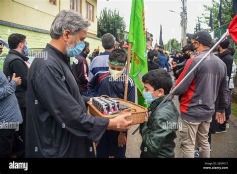 People Distribute Drinks Among Kashmiri Shia Mourners During The