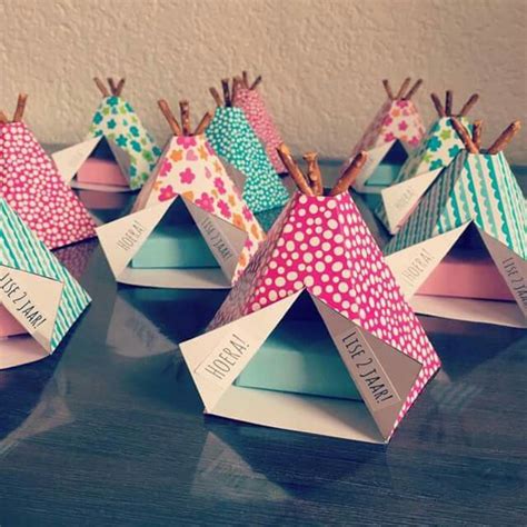 Small Colorful Tents With Name Tags On Them Sitting On A Table Next To