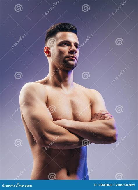 Portrait Of Confident Muscular Shirtless Man With Crossed Arms Stock