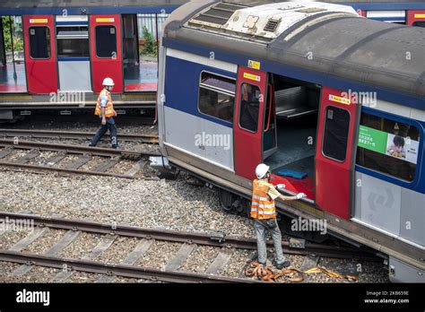 Mtr Workers Are Seen Inspecting A Derailed Mtr Passengers Train Near