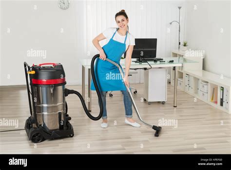 Female Janitor Cleaning Floor With Vacuum Cleaner Stock Photo Alamy