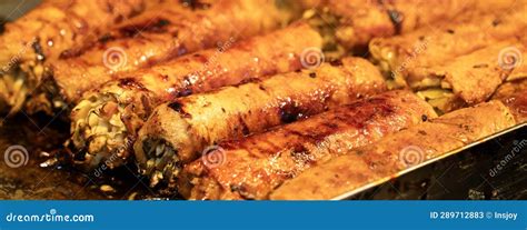 Grilling Barbecue Meatloaf Rolled With Vegetables At Traditional Night