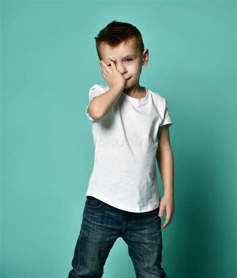 Portrait Of Unhappy Sad Bored Kid Boy Leaning Head On Palm Looking With