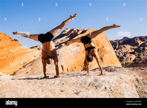 Two Gymnasts Doing Handstands In Desert State Park Overton Nevada